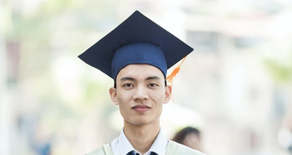 a boy wearing graduation cap